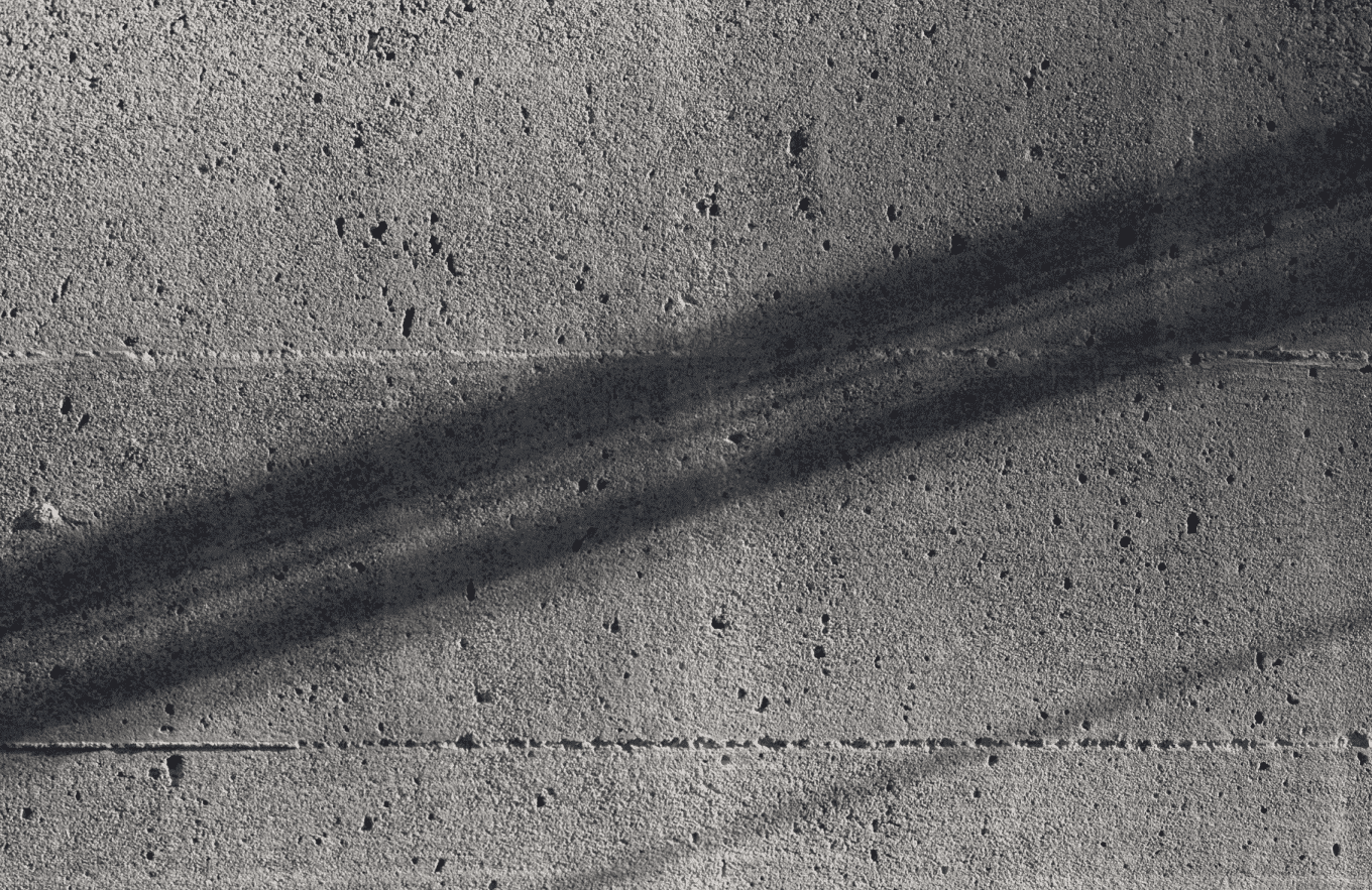 image of grainy grey brick wall with a shadow on it